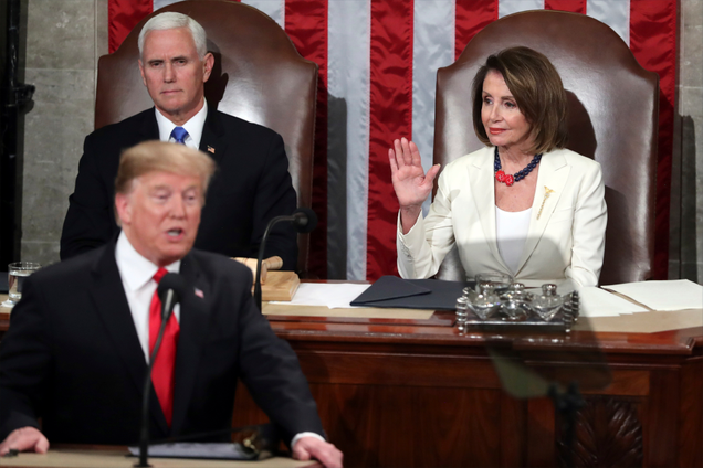 Speaker of the House Nancy Pelosi, D-Calif., raises her hand in a gesture to quiet the Democrats as President Donald Trump delivers his State of the Union address to a joint session of Congress on Capitol Hill in Washington, as Vice President Mike Pence watches, Tuesday, Feb. 5, 2019.